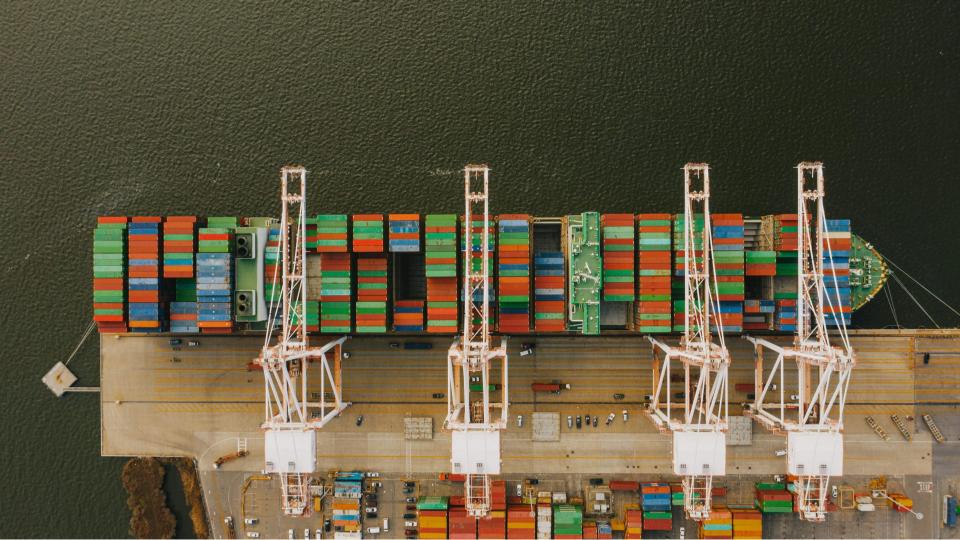 Top-down view of shipping containers at dock