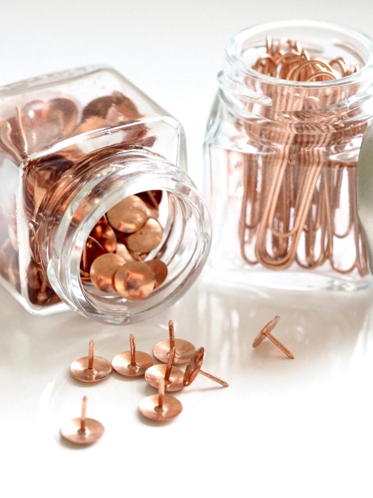 Copper thumbtacks and paperclips in glass jars