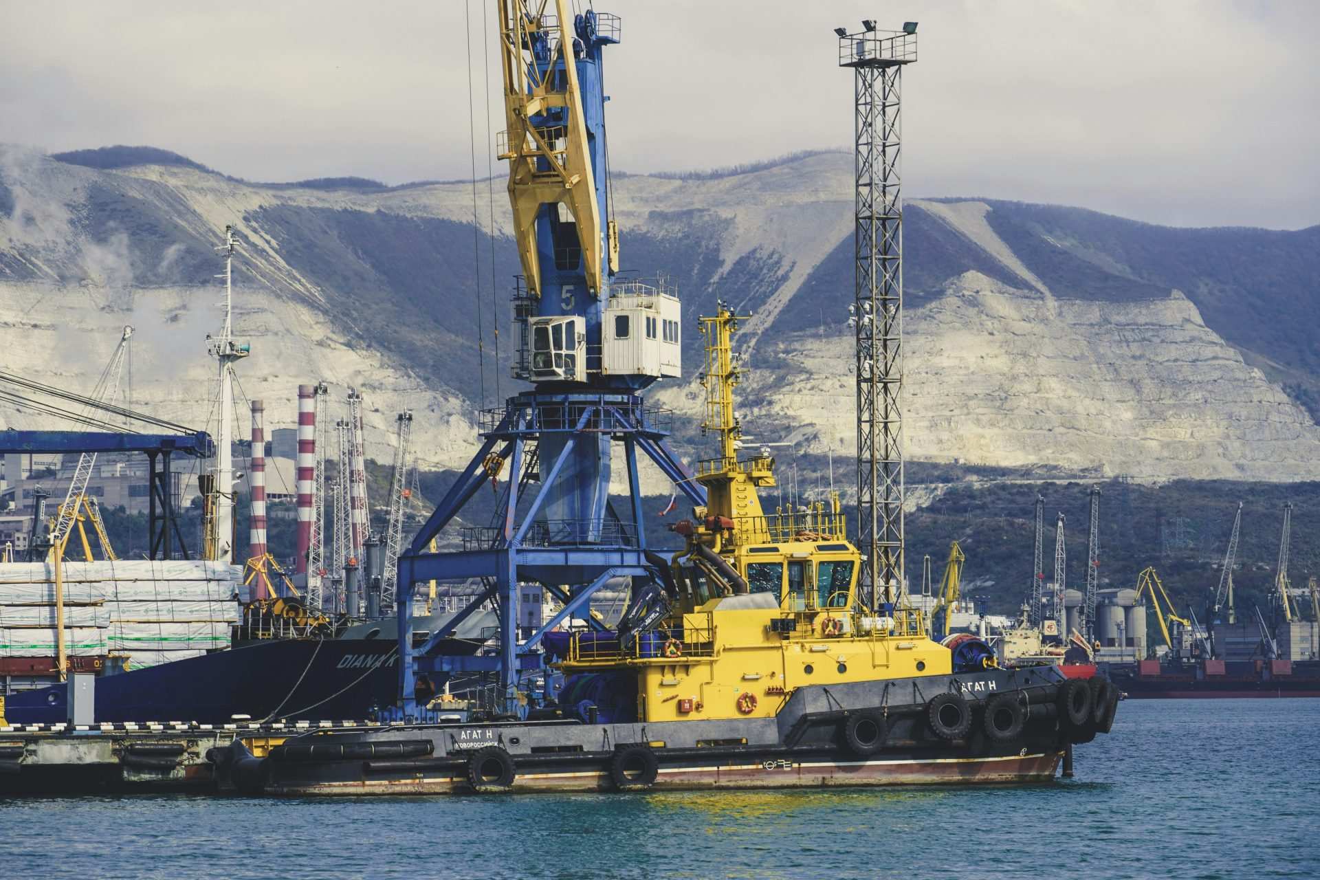 Large tugboat and crane in a shipyard